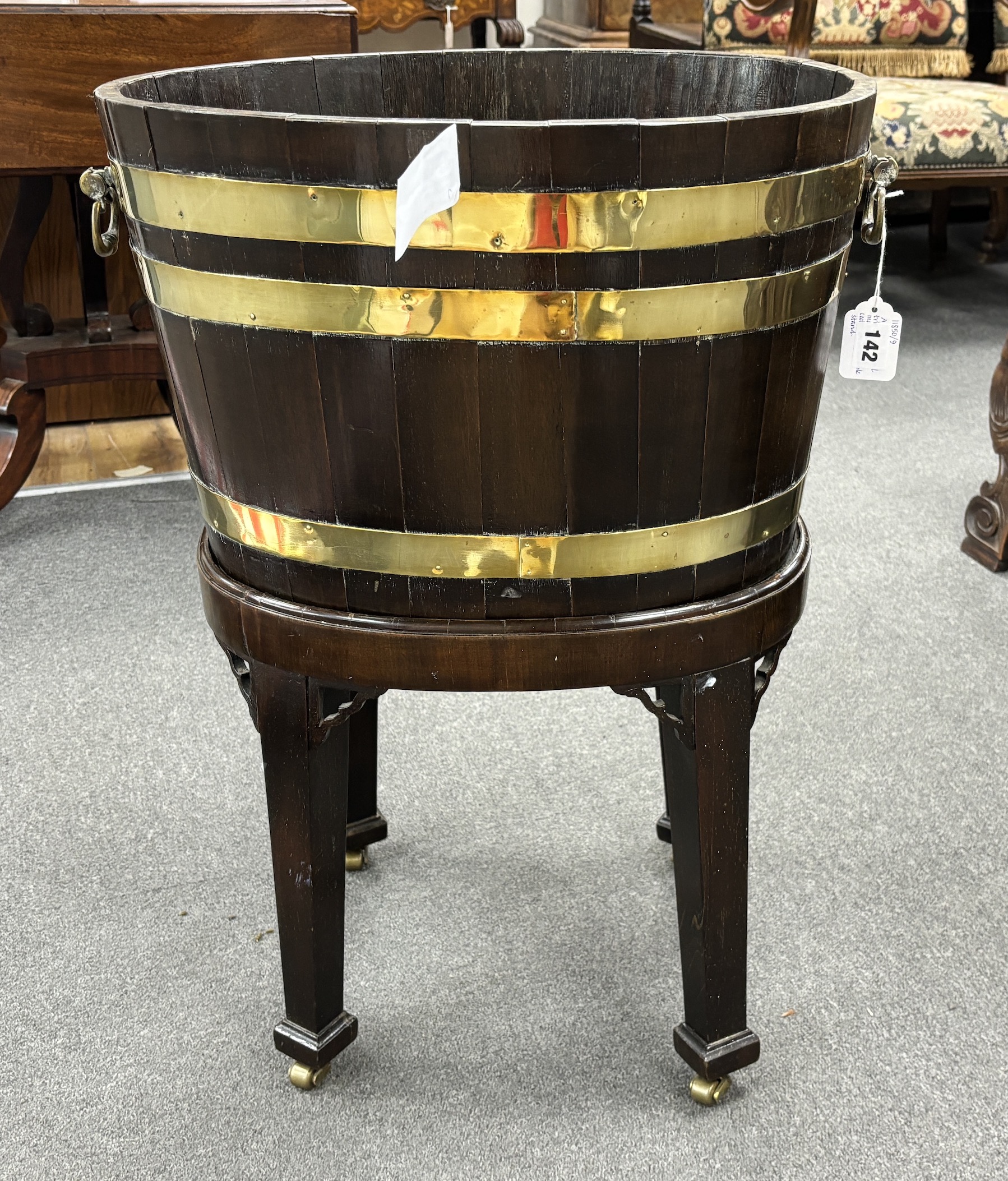 A George III triple brass bound mahogany wine cooler, on a detachable stand, width 48cm, depth 38cm, height 69cm